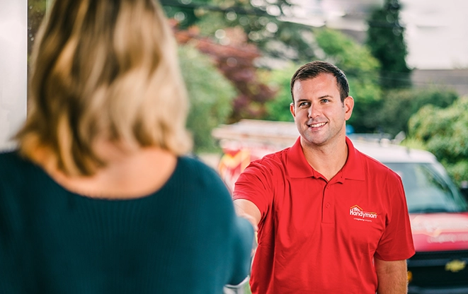 Mr. Handyman greeting customer at the door.