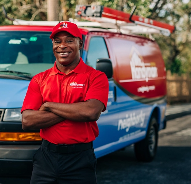 Mr. Handyman professional in front of van.