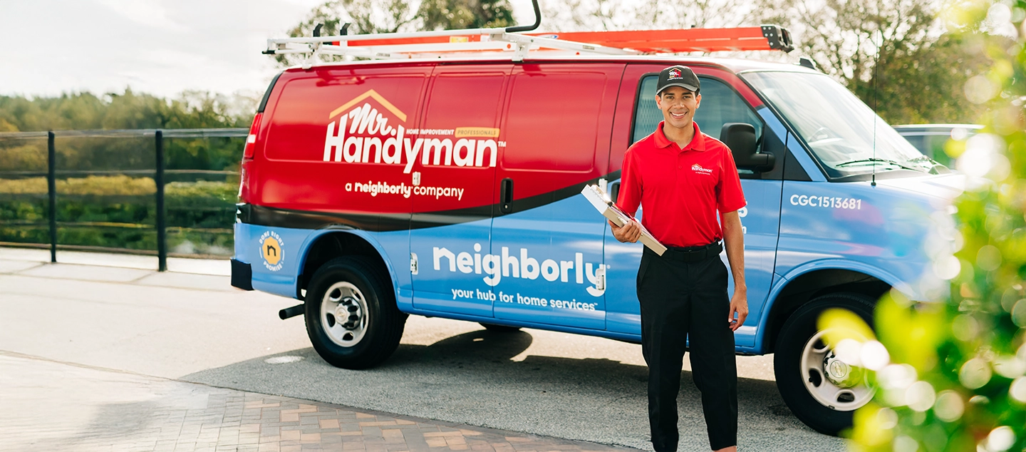 Mr. Handyman van with worker standing in front.