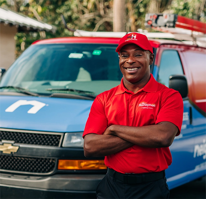 A service professional standing in front of a van.