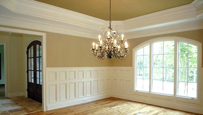 Interior great room with chandelier closeup and wainscoting.
