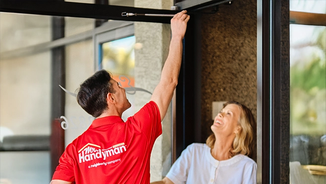 MRH employee fixing a store's door.