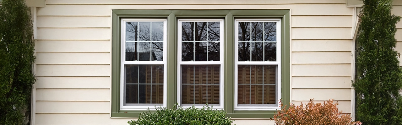 Three windows with green trim.
