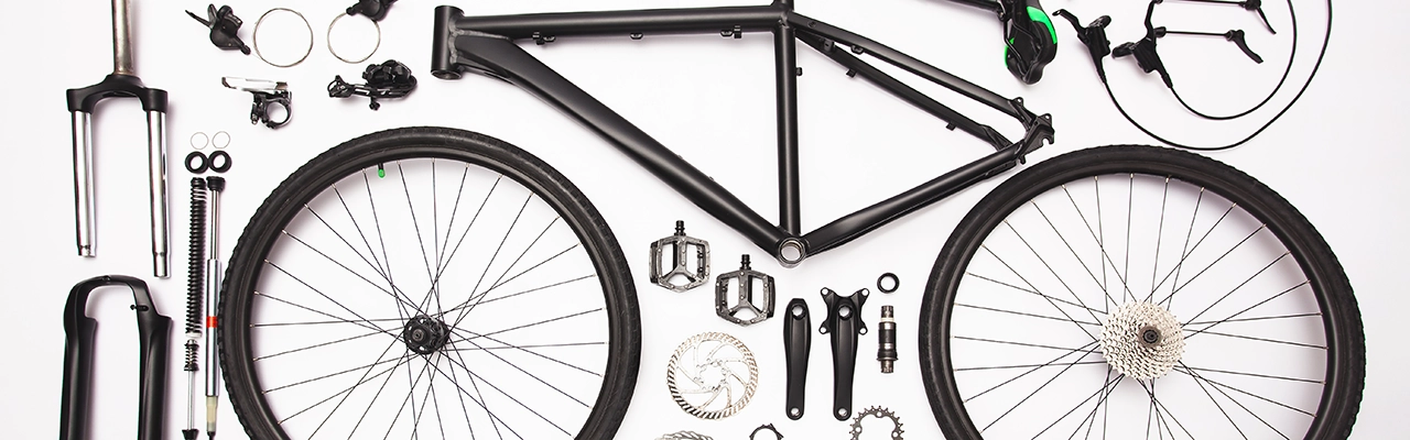 Bicycle parts laid out neatly.