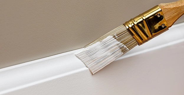 Painting molding with brush.