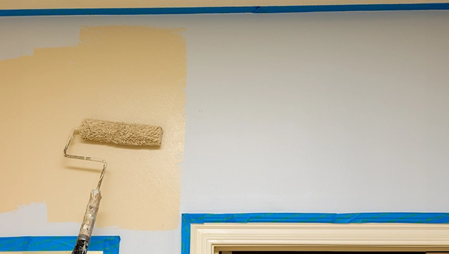 Paint roller on an interior wall.