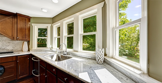 A row of white-framed windows above kitchen sink.