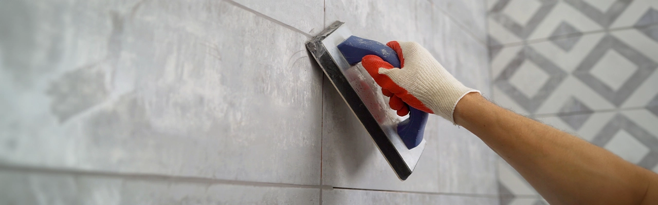 Grouting wall tile.