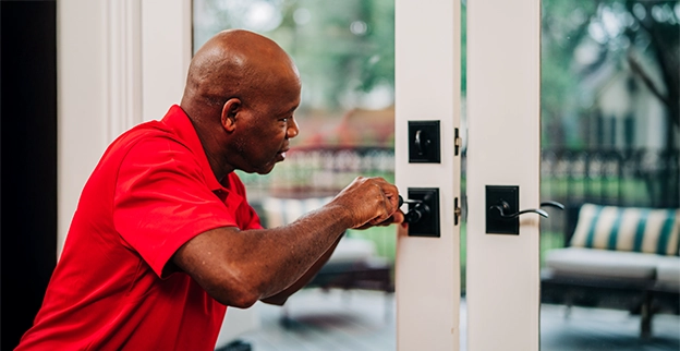 Mr. Handyman repairing door.