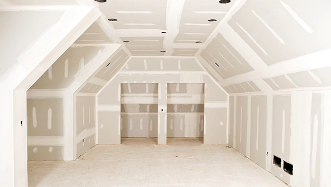 Sheetrock covering ceiling and walls of room.