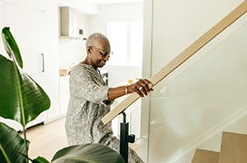 Woman using staircase modification.