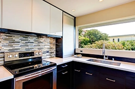 Kitchen with wide window and backsplash.