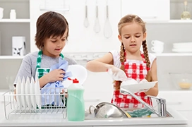 Two kids in a kitchen.
