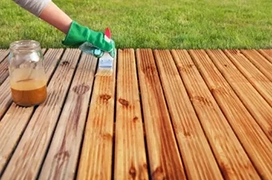 Staining a deck by hand.