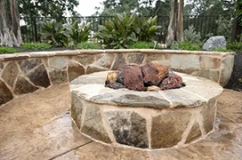 Stone fire pit with surround.