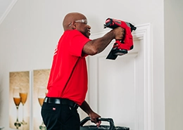 Mr. Handyman adding door molding.