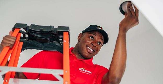 My Handyman technician installing a light fixture.