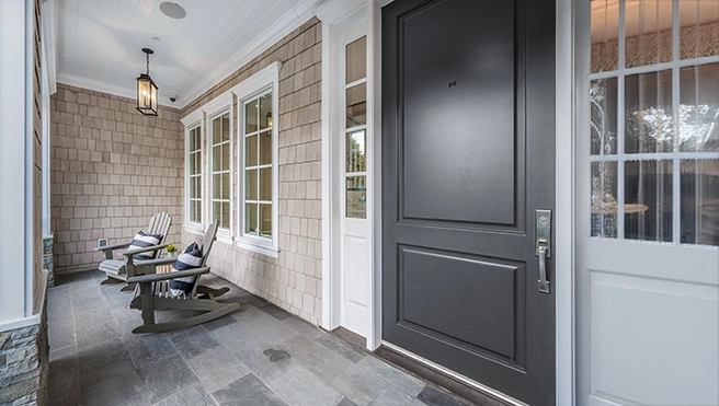 A picture of a large black front door of a home.