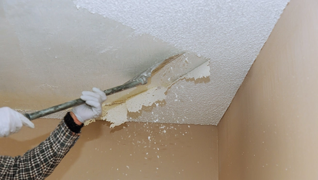 A picture of popcorn ceiling being removed.
