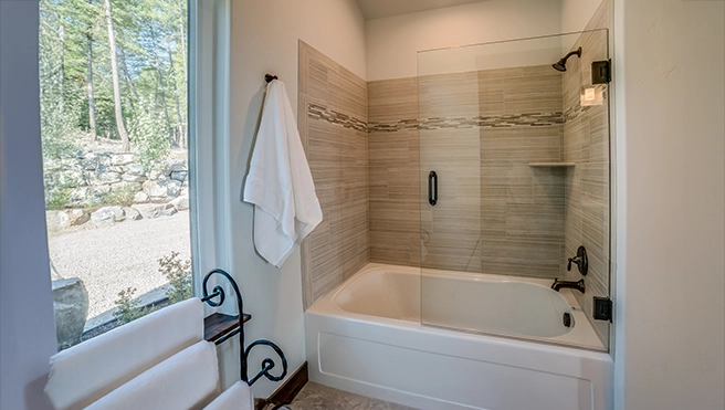 A picture of a tub enclosure with half glass.