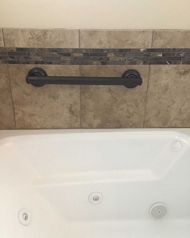 Black grab bar in a bathroom