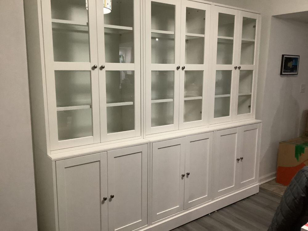 Grey and white China cabinet assembled with glass doors