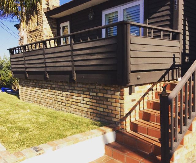 Wooden deck on front of house.