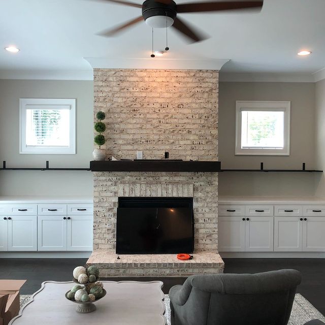 Installed custom built in cabinets and shelves on either side of fireplace.  Custom wood countertops on the base cabinets and rustic shelves stained to match the mantle