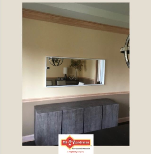 Mirror on wall above cabinet.