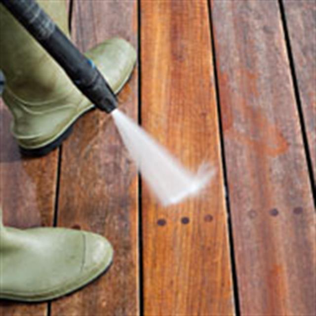 Power washing a deck.