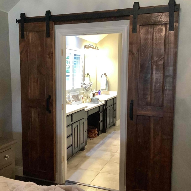 Dark wood sliding barn door upgrade to a bathroom.