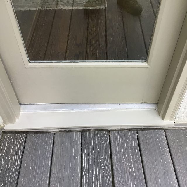 Replaced rotted wood threshold.  Cut and removed rotted material on threshold and door jambs and replaced with new material, caulked and painted.
