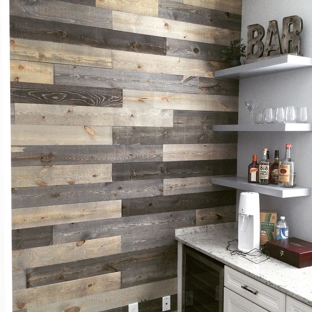 Rustic shiplap wall covering in bar area and installed floating shelves