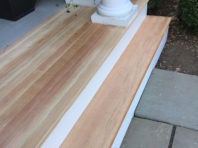 This a set of wooden steps that have been added to the front porch of a home.