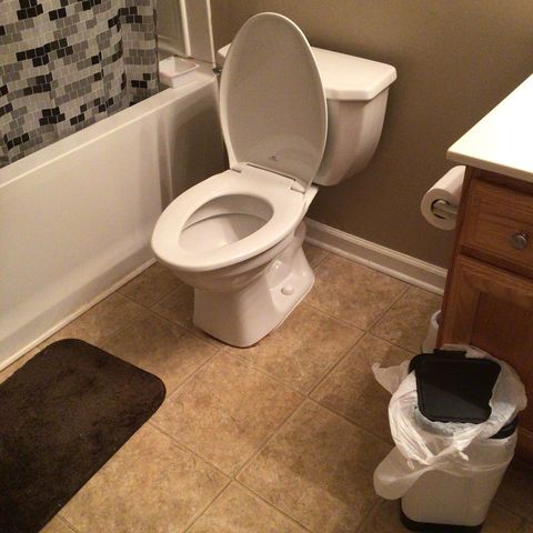 toilet in tan tiled bathroom
