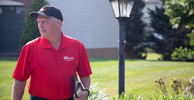 Mr. Handyman technician carrying an iPad.