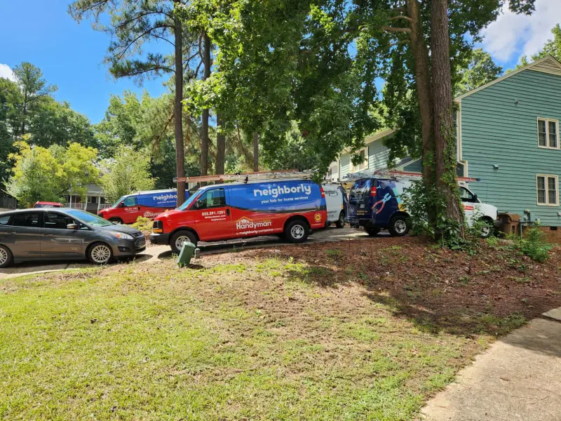 A Mr. Handyman branded van parked in the driveway of a home.