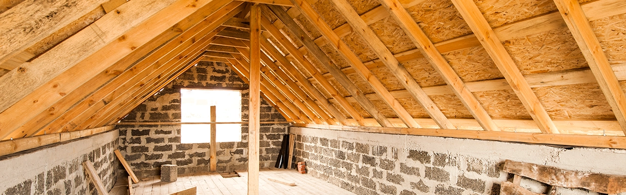 Attic Insulation of house with wooden beam.