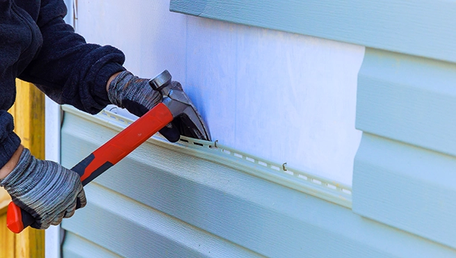 MRH employee working on wall replacement.