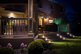 Exterior lights on house at night.