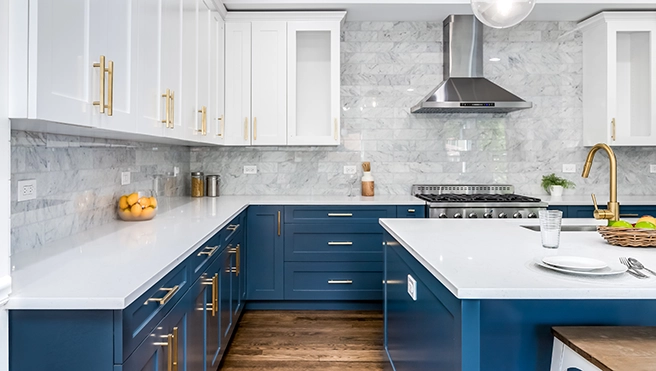 Modern kitchen featuring navy blue cabinets, white countertops.