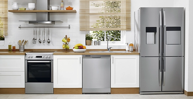 Modern kitchen with white cabinets, stainless steel appliances.