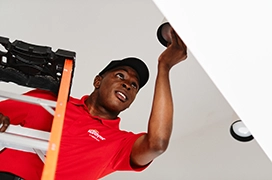 MRH technician fixing a light.