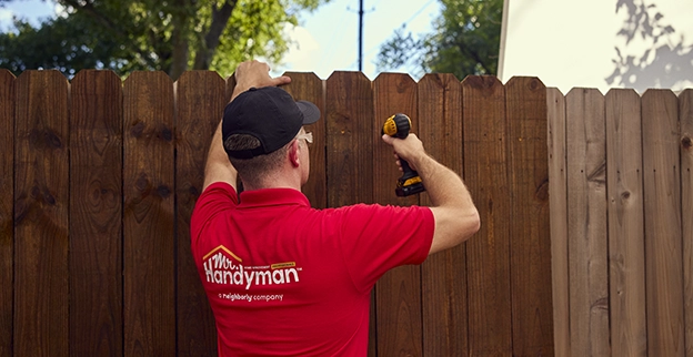 MRH employee using drill on wood panel.