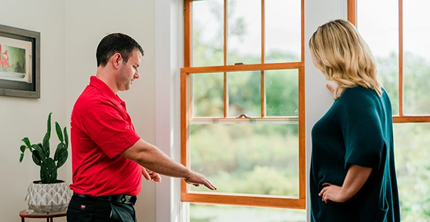 MRH employee explaining the installation process of a new window.