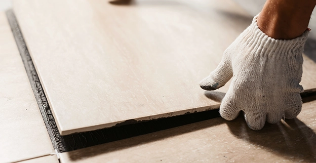Handyman carefully placing a tile.