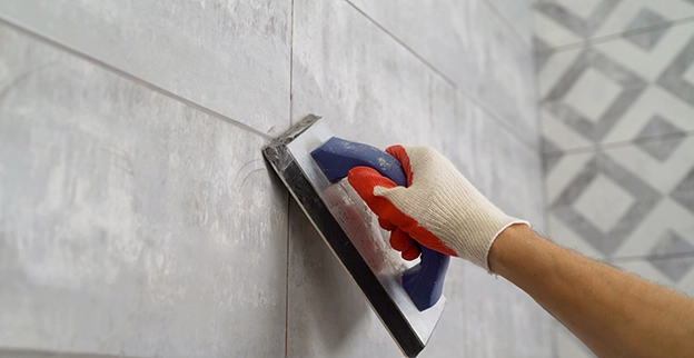 Grouting ceramic tile.