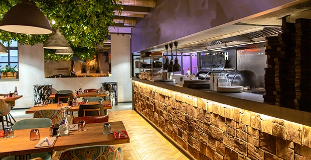 Modern restaurant interior featuring wooden tables.