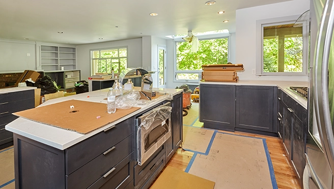 A partially renovated kitchen with dark cabinets.