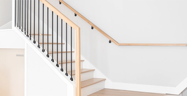 Wooden staircase with wooden handrail.